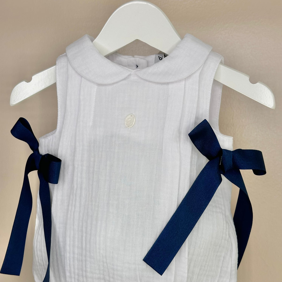 White Sleeveless Romper With Navy Bows